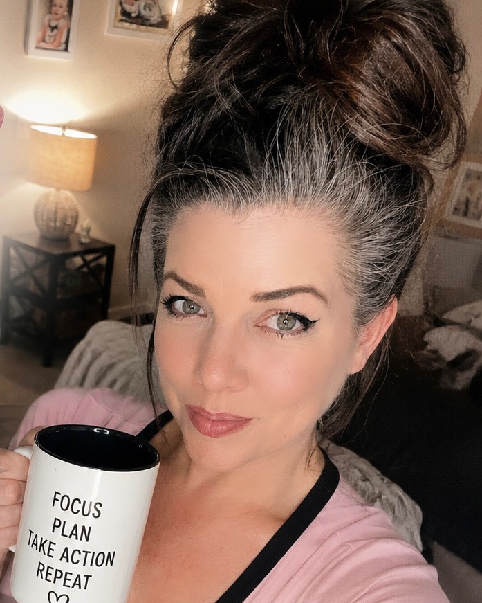 Danielle Munoz holding a mug that reads Focus Plan Take Action Repeat
